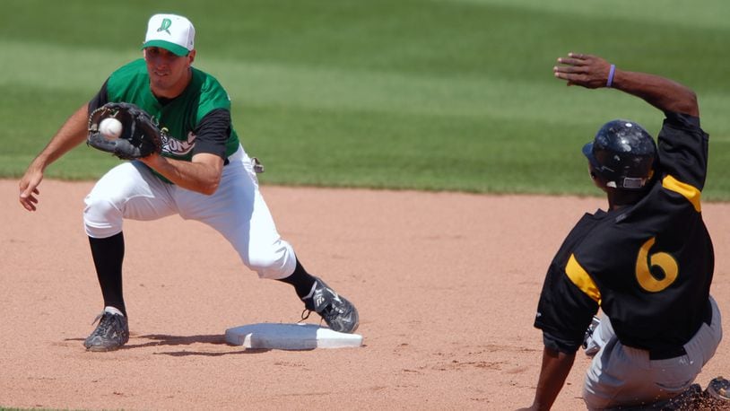 Dayton Dragons shortstop Adam Rosales tags out South Bend’s Justin Upton on a steal attempt on June 25, 2006, at Fifth Third Field. STAFF FILE PHOTO