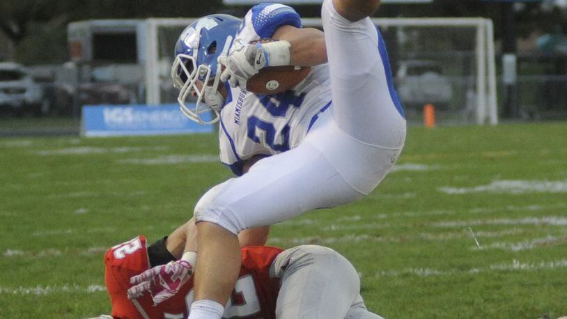 Miamisburg’s Tony Clark (top) is upended by Troy’s Jacob Anderson. Miamisburg defeated Troy 21-17 in a Week 5 high school football GWOC crossover game at Troy’s Memorial Stadium on Friday, Sept. 23, 2016. MARC PENDLETON / STAFF