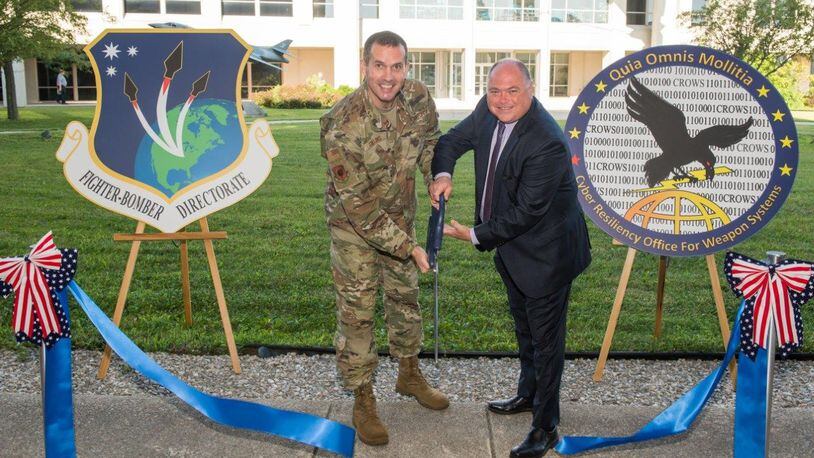 Brig. Gen. Heath Collins, program executive officer, Fighters and Bombers Directorate, and Joseph Bradley, director for the Cyber Resiliency Office for Weapons Systems, officially open a cyber defense facility for the Air Force Life Cycle Management Center’s Fighters and Bombers Directorate, Wright-Patterson Air Force Base. (U.S. Air Force photo/Wesley Farnsworth)