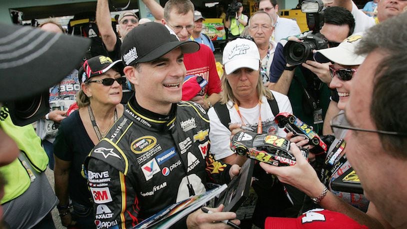 NASCAR driver Jeff Gordon signs autographs for fans during the Ford EcoBoost 400 Sprint Cup Series practice on Saturday, Nov. 21, 2015, at Homestead-Miami Speedway in Homestead, Fla. (Andrew Uloza/Miami Herald/TNS)