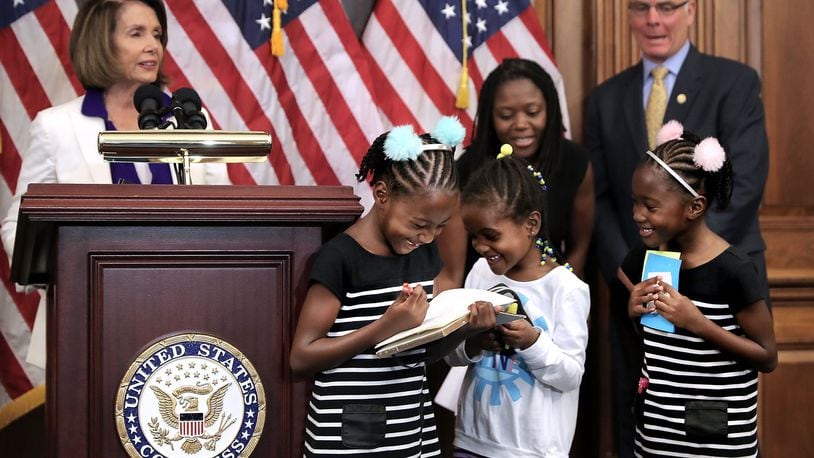 Shiloh Tappin (R), her twin sister Seilah Tappin (3rd R) and their friend Dani Hebron, all 7 years old, take notes during a news conference conducted by House Minority Leader Nancy Pelosi (D-CA) in the Rayburn Room at the U.S. Capitol November 3, 2017 in Washington, D.C. Virtually every Democrat opposed a GOP measure to extend the children’s health insurance program for five years because they say Republicans are using children’s health to chip away at the 2010 health law known as Obamacare. (Photo by Chip Somodevilla/Getty Images)