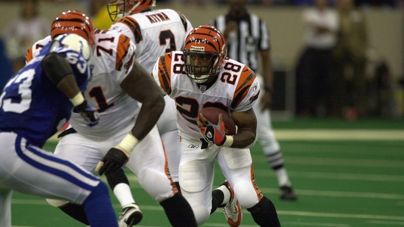 Former Bengals running back Corey Dillon runs behind a block by tackle Willie Anderson in a game against the Colts on October 6, 2002 in Indianapolis.