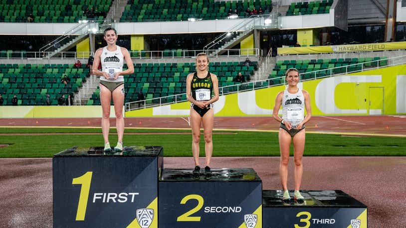 Alter graduate Abby Nichols, left, stands atop the podium at the Pac-12 track and field championships after winning the 10,000-meter race at Hayward Field in Eugene, Ore., on May 13, 2022. Photo by Tyler Davis/CU Athletics