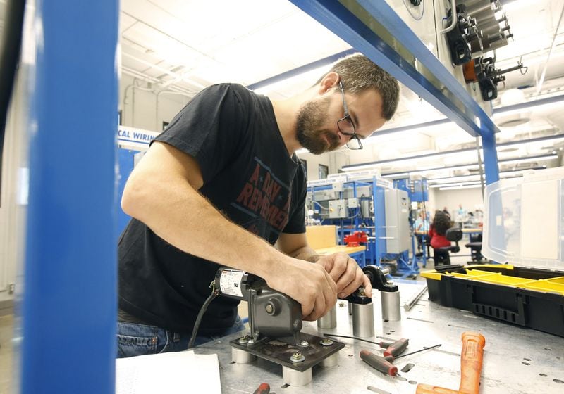 Zac Cox, 29, completes course work in Sinclair’s Manufacturing Solutions program to improve his skills as a maintenance technician for his employer, F&P America Manufacturing in Troy. Auto parts producer F&P America, on Corporate Drive in Troy, with Bellefontaine-based Humble Construction, have applied for a 36,109-square-foot expansion, one valued at $3 million, recent Miami County records indicate. TY GREENLEES / STAFF