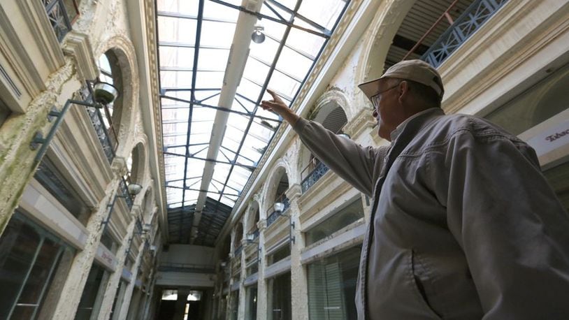 John Gower, CityWide’s urban design director, leads a tour through the Third Street arcade section of the Dayton Arcade. FILE