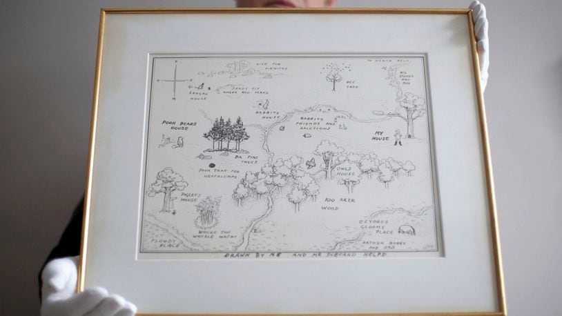In this photo dated May 31, 2018,  Philip W. Errington holds the original map of Winnie-the-Pooh's Hundred Acre Wood by E H Shepard.  Shepard's 1926 hand drawn original map has sold at auction in Sotheby's in London on Tuesday July 10, 2018, for 430,000 pounds (US dollars 571,000), a record price for a book illustration.