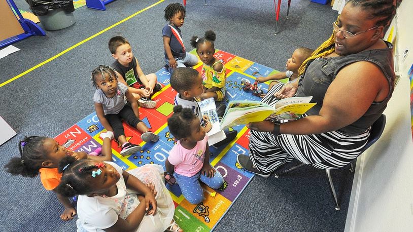 Danaye Scott reads to her class at the On Purpose Academy and Mentoring Center in Dayton. MARSHALL GORBY / STAFF