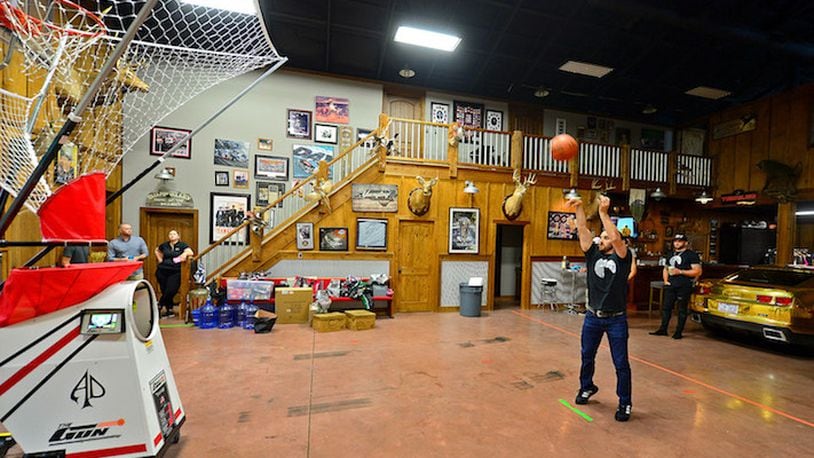 NASCAR Cup Series driver Austin Dillon practices shooting baskets in his home. Dillon lives in a barn where he lives with his wife, Whitney and entertains his friends along with broadcasting his podcast Barn Life. (Jeff Siner/Charlotte Observer/TNS)