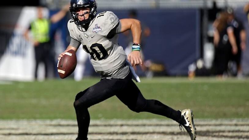 Central Florida quarterback McKenzie Milton scrambles during the second half of the American Athletic Conference championship NCAA college football game against Memphis, Saturday, Dec. 2, 2017, in Orlando, Fla.  Central Florida won in overtime 62-55. (AP Photo/John Raoux)