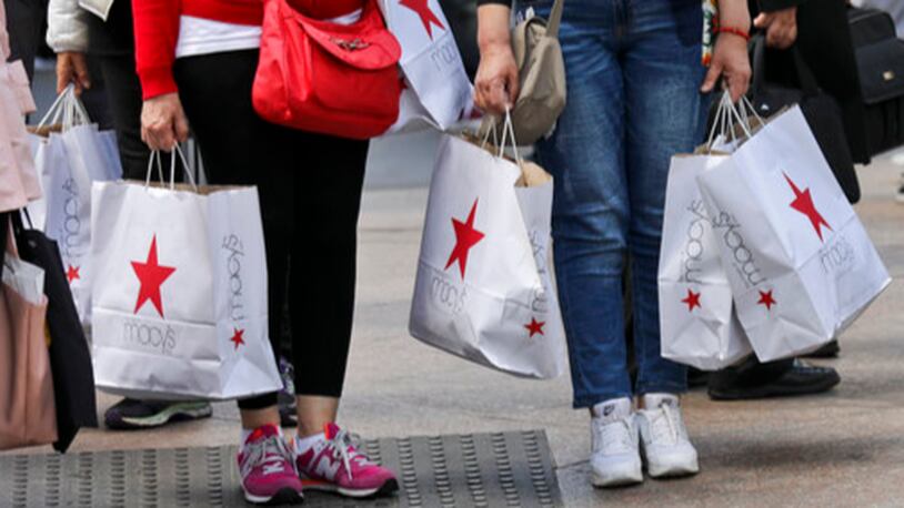 In this Tuesday, May 2, 2017, photo, shoppers holding bags from Macy's wait to cross an intersection in New York. Macy's Inc. reports earnings, Thursday, May 11, 2017. (AP Photo/Bebeto Matthews)