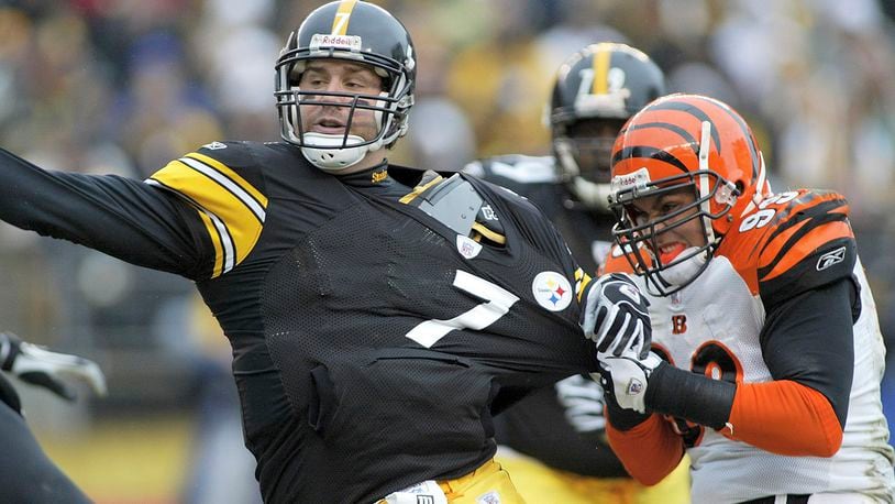 PITTSBURGH, PA- DECEMBER 4: Ben Roethlisberger #7 of the Pittsburgh Steelers throws the ball away as David Pollack #99 of the Cincinnati Bengals tries to sack him on December 4, 2005 at Heinz Field in Pittsburgh, Pennsylvania. (Photo by Rick Stewart/Getty Images)