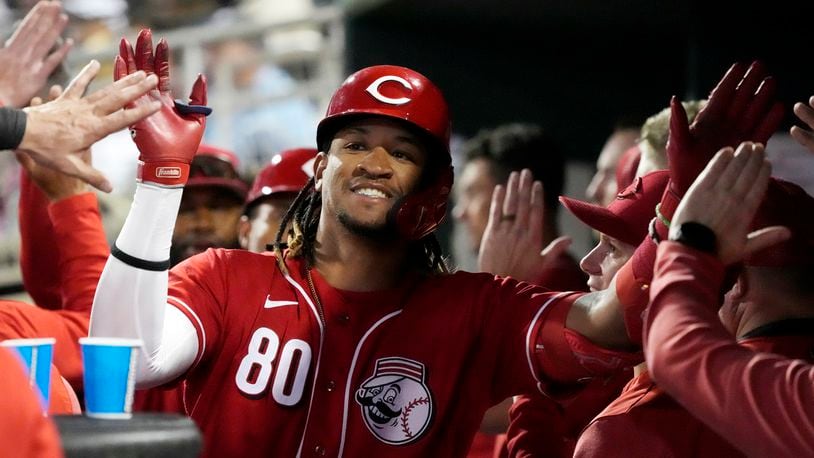 Cincinnati Reds' Allan Cerda (80) celebrates with teammates in the dugout after his two-run home against the Colorado Rockies during the second inning of a spring training baseball game Monday, March 6, 2023, in Goodyear, Ariz. Cerda scored a run and had an RBI in Chattanooga's improbable 7-5 win on Saturday despite no hits. (AP Photo/Ross D. Franklin)