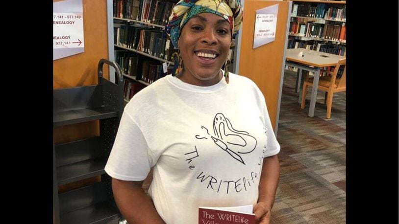 Dayton area resident shared stories of survival as part of the Dayton Strong Storytelling Sessions recorded at the Dayton Metro Library. Latesa Williamson, the Dayton poet and performer known as A Slate, of  The WRITElife Village is pictures. She holds a book of poems written by children following the tornadoes.