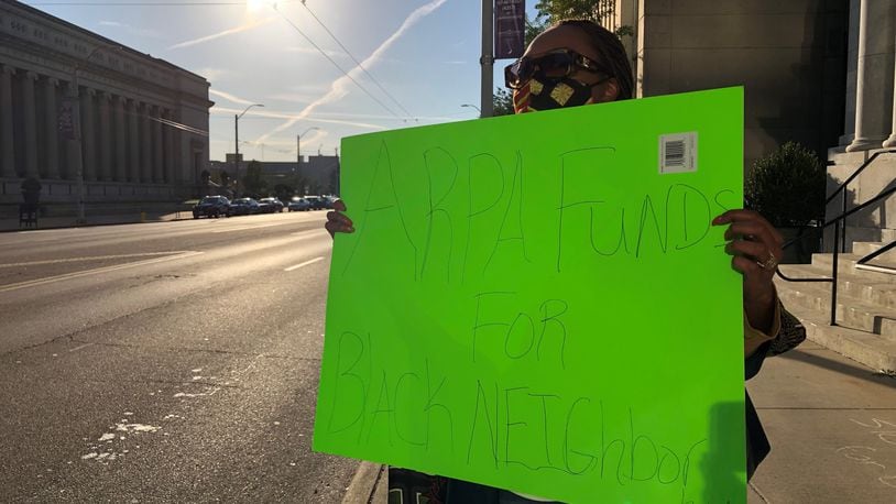A small group of protestors gathered outside of City Hall to demand the city of Dayton push back its deadline for applications for federal rescue funds. Protestors held signs with messages like, "ARPA funds for Black neighborhoods." CORNELIUS FROLIK / STAFF