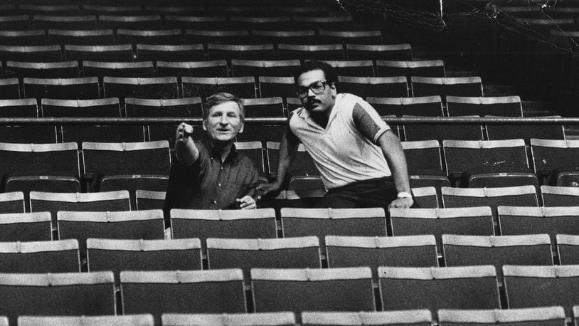 UD Arena manager Joe Eaglowski, left, talks with concert promoter Jerry Dickerson about seating and stage placement before a show at the arena in 1980. Dayton Daily News photo by Charles Steinbrunner