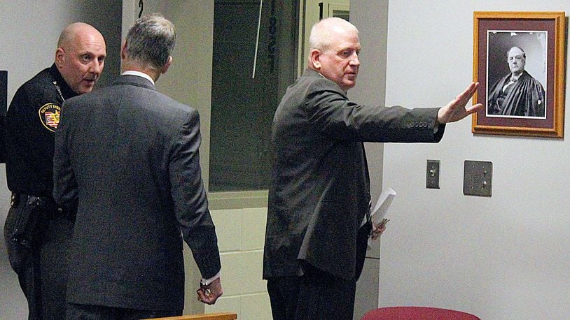 Former Indian Lake superintendent (right) Patrick O’Donnell waves good-bye to family and friends as he leaves a Logan County courtroom after being sentenced to four and one half years in prison during a sentencing hearing. JEFF GUERINI/STAFF