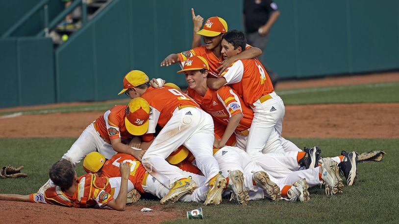 The baseball team from River Ridge, Louisiana, celebrates the 8-0 win against Curacao in the Little League World Series Championship game in South Williamsport, Pa., on Sunday, Aug. 25, 2019.