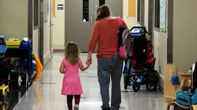 Jannet Pikos walks her daughter Mycah, 3, to preschool class at United Rehabilitation Services, 4710 Troy Pike in Montgomery County on Tuesday April 4, 2023. MARSHALL GORBY\STAFF