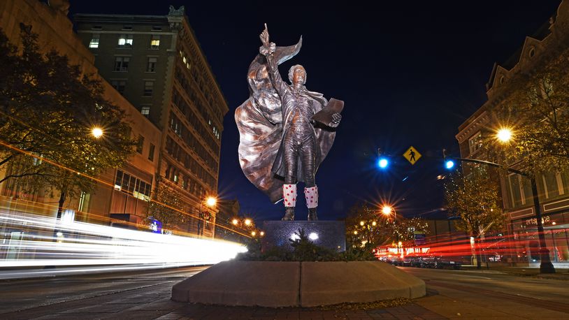 Car lights are blurred during a 20-second exposure of The American Cape sculpture of Alexander Hamilton, by metal sculptor Kristen Visbal, as cars drive by on High Street in Hamilton. NICK GRAHAM/STAFF