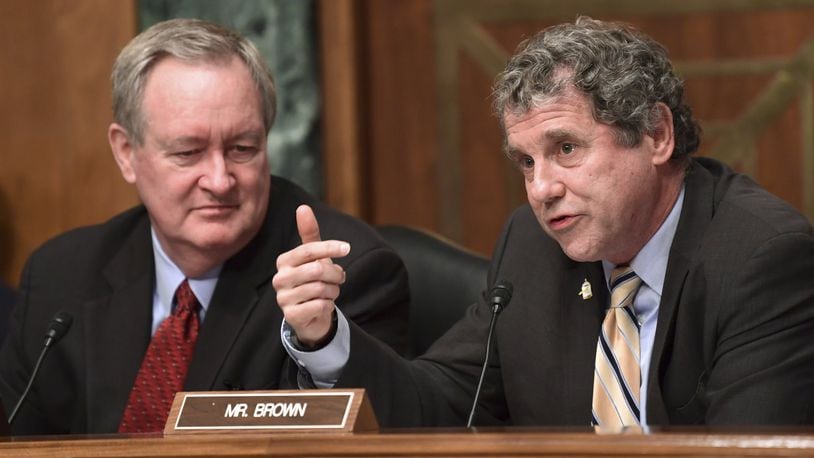 Senate Banking, Housing and Urban Affairs Committee ranking member Sen. Sherrod Brown, D-Ohio, right, sitting next to committee chairman Sen. Mike Crapo, R-Idaho, left, asks a question of Wells Fargo Chief Executive Officer Timothy Sloan on Capitol Hill in Washington, Tuesday, Oct. 3, 2017. (AP Photo/Susan Walsh)