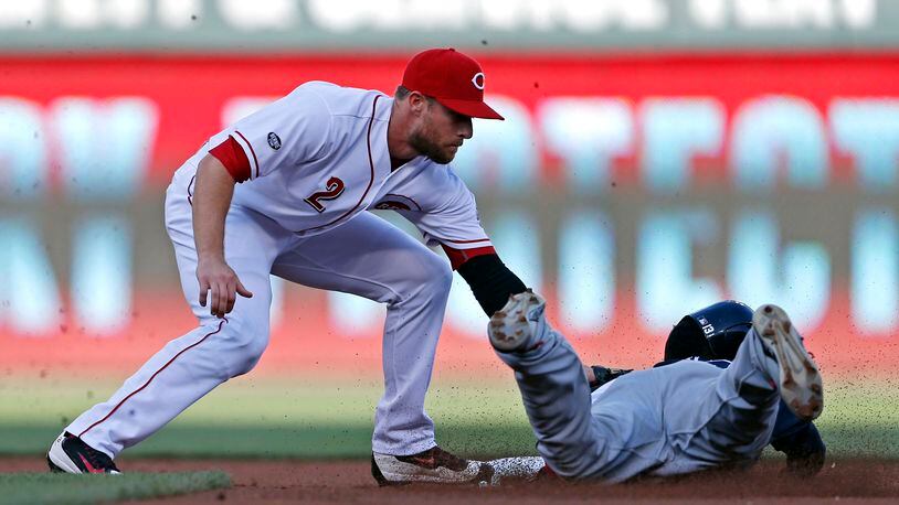 Cincinnati Reds shortstop Zack Cozart (2) puts the tag on Atlanta Braves Adonis Garcia on a steal-attempt during the first inning of a baseball game, Monday, July 18, 2016, in Cincinnati. (AP Photo/Gary Landers)