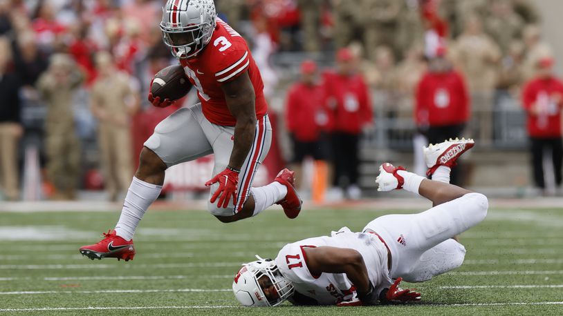 Ohio State running back Miyan Williams, left, leaps over Rutgers linebacker Deion Jennings during the first half of an NCAA college football game, Saturday, Oct. 1, 2022, in Columbus, Ohio. (AP Photo/Jay LaPrete)