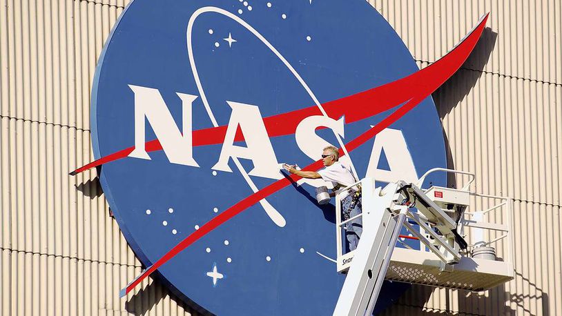 A painter freshens up the NASA logo that adorns NASA Glenn Research Center's Flight Research Building, or airplane hangar. Affectionately coined "the meatball," the blue logo makes the hangar the most recognized of NASA Glenn's facilities