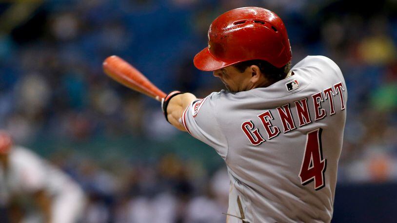 Scooter Gennett #4 of the Cincinnati Reds follows through on his swing after hitting a two-run home run off of pitcher Jake Odorizzi of the Tampa Bay Rays during the sixth inning of a game on June 19, 2017, at Tropicana Field in St. Petersburg, Fla.
