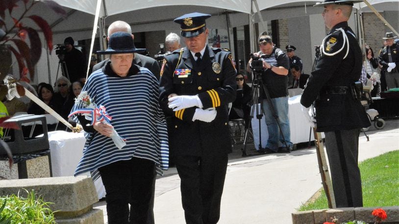 Nancy Mulder, widow of Piqua Ptlm. Jan Mulder II is escorted to the Miami County Law Enforcement Memorial in Troy during the annual Police Memorial Day ceremony May 3. Mulder died Aug. 11, 1970, during a shootout at the Fort Piqua Hotel. CONTRIBUTED