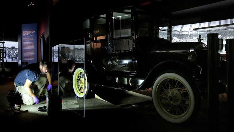 Exhibit preparator B.J. Vogt works on the presentation of the 1927 Model T Fordor on Tuesday, Aug. 29, 2017, at the Missouri History Museum. The dress and photo of the ball are part of the Panoramas of the City exhibit, which explores the history of the city from 1900 to 1950 through the use of panoramic photos. (Laurie Skrivan/St. Louis Post-Dispatch/TNS)