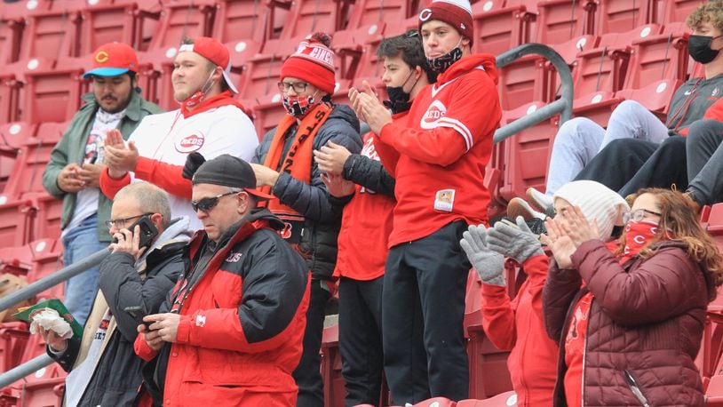 Reds fans cheer during a pregame ceremony on Opening Day on Thursday, April 1, 2021, at Great American Ball Park in Cincinnati. David Jablonski/Staff