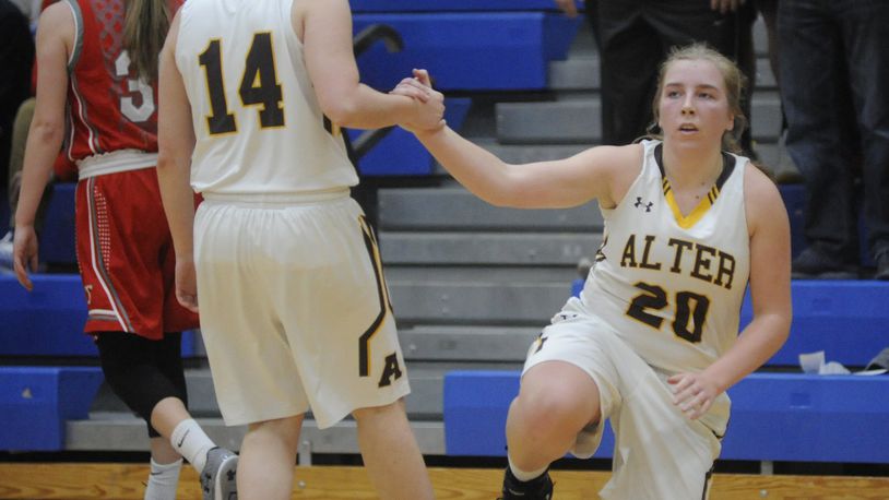 Alter’s Emily Long (20) gets a helping hand from Kourtney Klug. Alter defeated Tippecanoe 50-41 in a girls high school basketball D-II regional semifinal at Springfield High School on Tuesday, March 7, 2017. MARC PENDLETON / STAFF