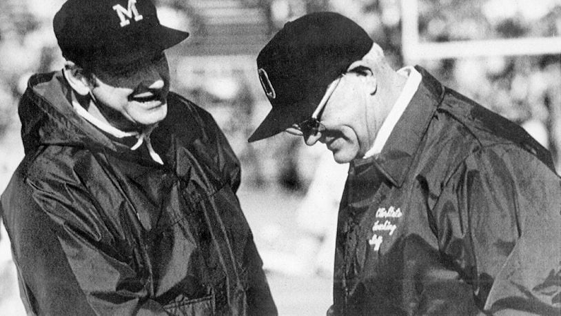 FILE - Michigan coach Bo Schembechler, left, meets with Ohio State coach Woody Hayes at an NCAA college football game. Ohio State and Michigan are making the Big Ten look like the Big Two and Little 12, rekindling memories of Woody Hayes and Bo Schembechler turning the chase for a conference championship into a two-team race. (AP Photo/File)