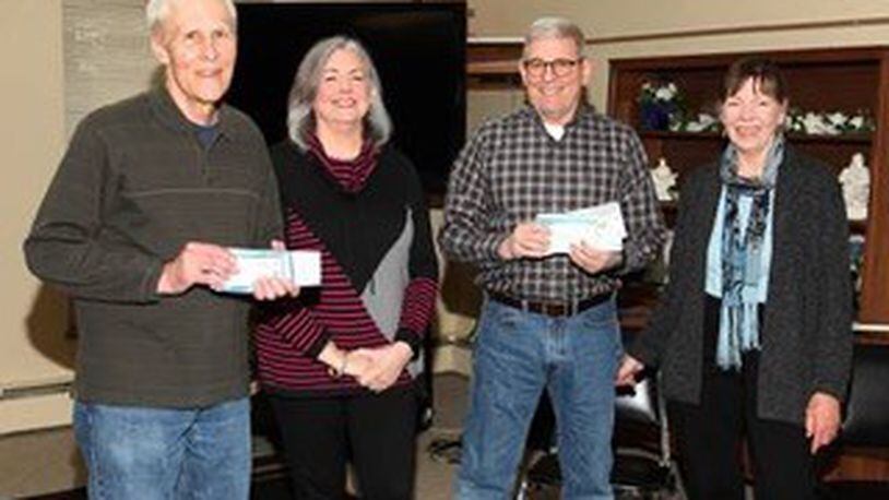 100+ Women Making a Difference in Greene County present a check to the St Vincent De Paul group at Mary Help of Christians church in Fairborn for their food pantry. Pictured left to right are JC Kelly, Rebecca Morgann, Tom Boland, Sandy McHugh. CONTRIBUTED