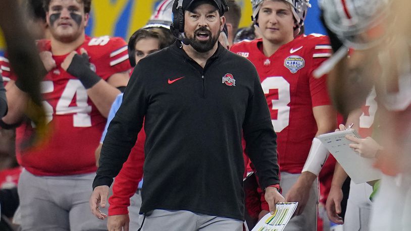FILE - Ohio State head coach Ryan Day, center, reacts on the sideline during the second half of the Cotton Bowl NCAA college football game against Missouri, Dec. 29, 2023, in Arlington, Texas. A person with direct knowledge of the move says Michigan is finalizing a deal hire running backs coach Tony Alford. The person spoke Wednesday, March 13, 2024 to The Associated Press on condition of anonymity because contract details and university approval were still being worked out. Wolverines coach Sherrone Moore pulled off a bold move in building his first staff after Jim Harbaugh's departure, adding one of Ryan Day's top assistants at Ohio State. Day hired Alford away from Notre Dame in 2015 as running backs and assistant head coach, promoting him to run game coordinator a little more than a year ago. (AP Photo/Julio Cortez, File)