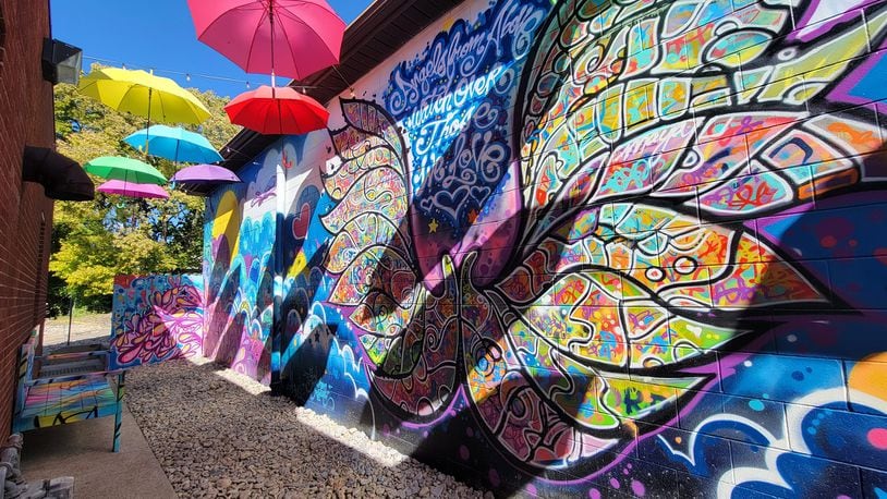 Angel Alley is dedicated in memory of the children from Mason City School District that were lost too soon. The centerpiece of Angel Alley is a large set of angel wings depicted on a wall mural with a colorful umbrella canopy overhead. CONTRIBUTED