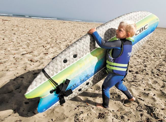 IMAGES: Surfing 3-year-old turning heads on Central Coast beach