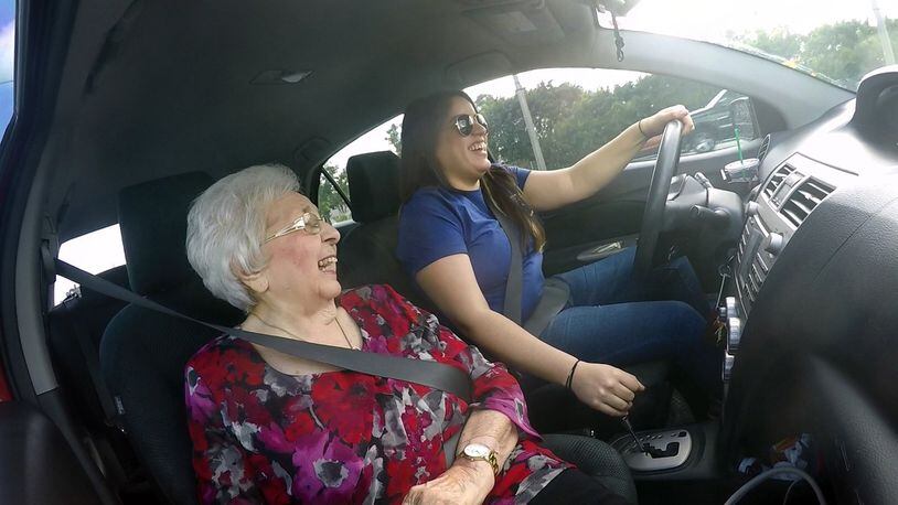Olga DeMartino, 92, shares a laugh with her Papa pal driver, Valeria Sosa, 26, as they return from DeMartino’s hair appointment on Tuesday, Nov. 14, 2017. Sosa is a Papa pal, employed by the startup. (Emily Michot/Miami Herald/TNS)