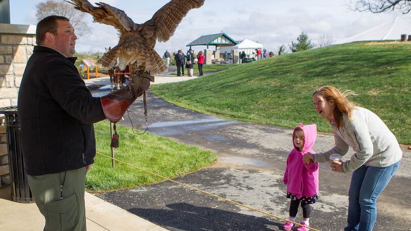 Harold Huffman’s great-great-niece Parker Guckenberger and her mom, Heidi, visit with Icarus the Owl and Shawn Connor of Heuston Woods during the 2012 dedication of Huffman Park in Fairfield. The city is hiring for a new parks director. STAFF FILE PHOTO
