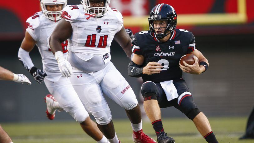 CINCINNATI, OH - AUGUST 31: Hayden Moore #8 of the Cincinnati Bearcats runs the ball as Pat Walker #44 of the Austin Peay Governors pursues at Nippert Stadium on August 31, 2017 in Cincinnati, Ohio. (Photo by Michael Hickey/Getty Images)