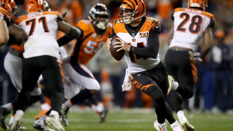 DENVER, CO - NOVEMBER 19:  Andy Dalton #14 of the Cincinnati Bengals lrolls out of the pocket against the Denver Broncos at Sports Authority Field at Mile High on November 19, 2017 in Denver, Colorado.  (Photo by Matthew Stockman/Getty Images)