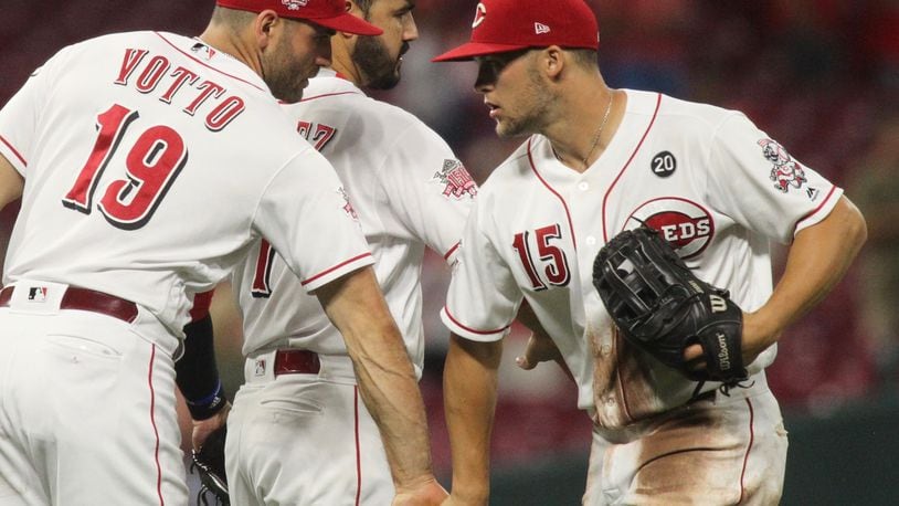 Reds players (left to right) Joey Votto, Eugenio Suarez and Nick Senzel celebrate after a victory against the Angels on Tuesday, Aug. 6, 2019, at Great American Ball Park in Cincinnati. David Jablonski/Staff