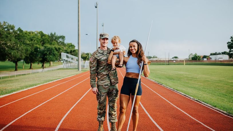 U.S. Army Warrant Officer 1 Devon Langhorst, a Blackhawk helicopter pilot and a former University of Dayton football standout, and his wife, former Olympic heptathlete Chantae McMillan, who will try to make the Tokyo-bound U.S. team this year in the javelin throw, pose last year with their son Otto at Fort Rucker in Alabama. Photo courtesy of Jenny Haury Photography