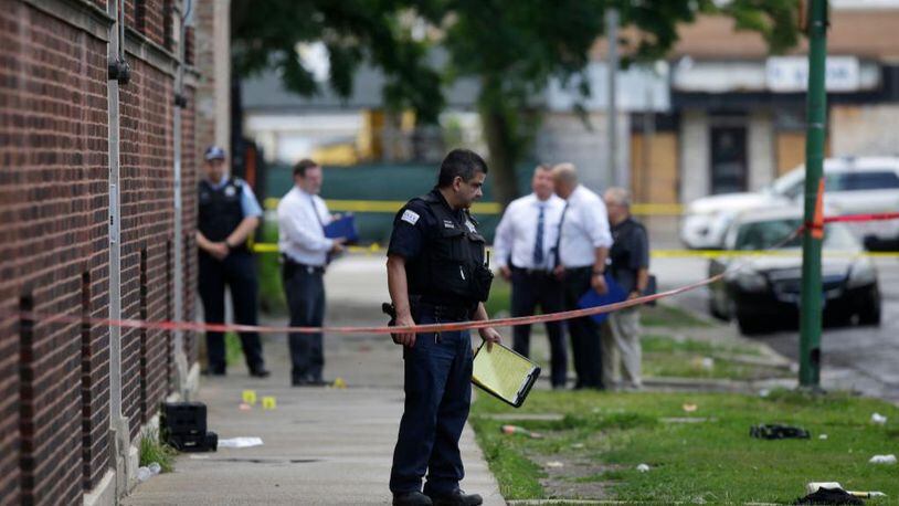 Chicago police officers and detectives investigate a shooting where multiple people were shot Sunday.