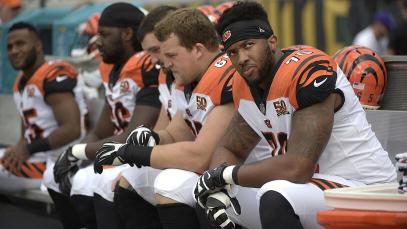 Cincinnati Bengals offensive tackle Cedric Ogbuehi (70) sits on the bench with other offensive linemen during the first half of an NFL football game against the Jacksonville Jaguars Sunday, Nov. 5, 2017, in Jacksonville, Fla. (AP Photo/Phelan M. Ebenhack)