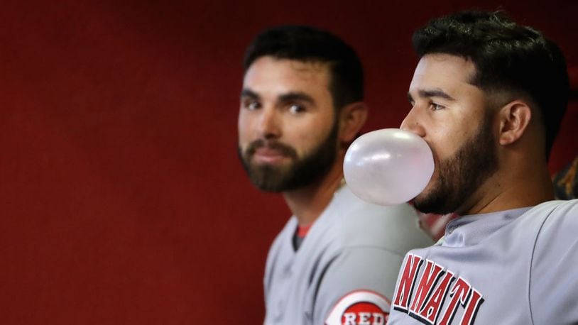 PHOENIX, AZ - JULY 09: Eugenio Suarez #7 (R) of the Cincinnati Reds blows a gum bubble alongside Jose Peraza #9 during the MLB game against the Arizona Diamondbacks at Chase Field on July 9, 2017 in Phoenix, Arizona. The Reds defeated the Diamondbacks 2-1. (Photo by Christian Petersen/Getty Images)