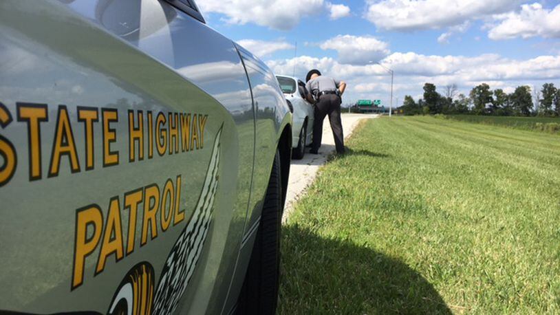 Ohio Highway Patrol Sgt. Frank Simmons speaks with a driver he pulled over on the access road to Dayton International Airport. Drivers near airports and on Friday afternoons are often distracted, law enforcement officers say. THOMAS GNAU/STAFF