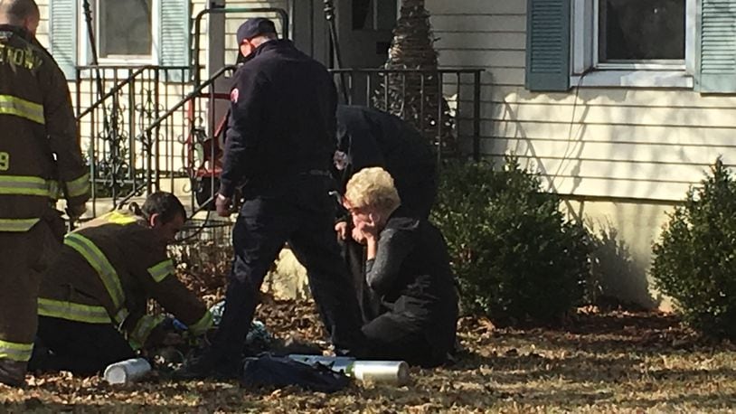 A woman is distraught as Middletown paramedics try to save her dog’s life. The dog apparently was trapped inside the burning home Friday morning on Bexley Drive. The dog was resuscitated and transported to a local veterinarian. RICK McCRABB/STAFF