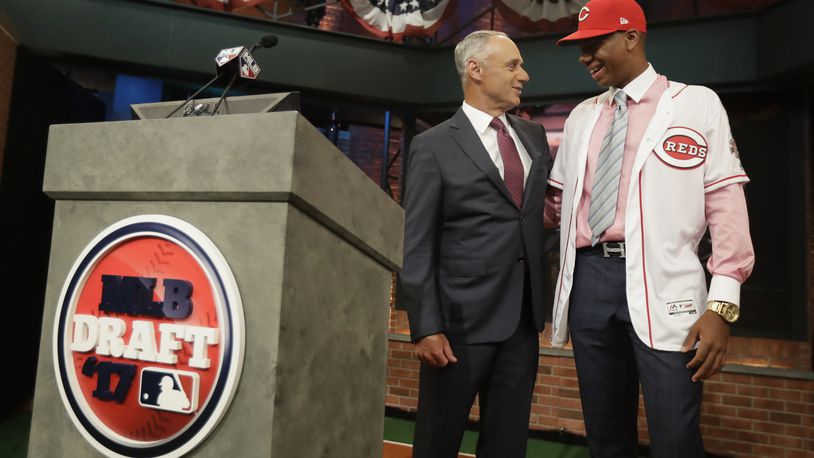Hunter Greene, right, a pitcher and shortstop from Notre Dame High School in Sherman Oaks, Calif., talks to commissioner Rob Manfred after being selected No. 2 by the Cincinnati Reds in the first round of the Major League Baseball draft, Monday, June 12, 2017, in Secaucus, N.J.(AP Photo/Julio Cortez)