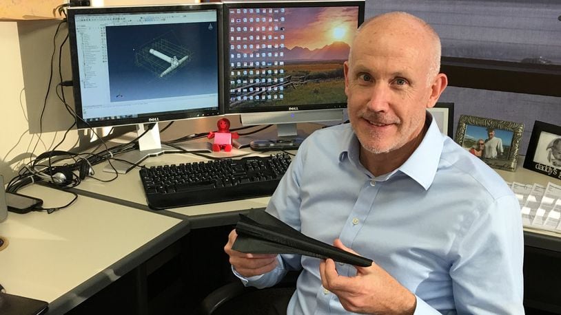 Steven E. Olson, a University of Dayton Research Institute researcher, holds a hypersonic aircraft model. CONTRIBUTED
